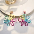 Handmade colorful raffia woven flower earrings for women on a white ceramic plate - Rainbow