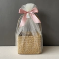 Detail of seagrass basket with white mesh wrap and a large pink ribbon bow for gifts - Nude Pink Full Wrap Snow Mesh