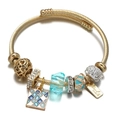 Detail of gold wire bangle with blue crystal beads and hollow heart charm decoration - Square Mosaic