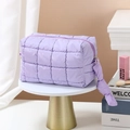 Quilted purple travel toiletry bag with zipper and handle on a golden pedestal - Octagonal Pouch / Light Purple