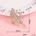 Golden wheat leaf brooch with white crystals measuring 36mm by 68mm on a pink background - D942 Rhinestone Flower
