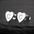 Detailed macro view of heart-shaped stainless steel earring featuring an engraved letter C - Letter C / Steel