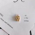 Macro view of a 16x9mm golden alloy hollow robot pendant on white textured paper - 7# Goggles Figure