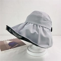 Close-up of wide brim sun hat with grey exterior and black UV lining on a stand - M (56-58cm) / Gray