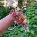 Detail of a transparent acrylic chicken charm with a Santa hat and Christmas lights - Christmas Chicken with Hat and Lights Pattern (款1)