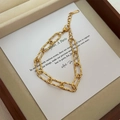 Golden stainless steel triple snake chain layered bracelet with textured metal links - E160 Textured Gold Bracelet