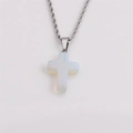 Macro shot of a silver twist chain necklace with an opal cross pendant on grey backdrop - Opalite Color