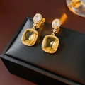 Close-up of 18K gold plated square earrings with large yellow gemstone and crystals - Ear Clip - Gold (Real Gold Plated)