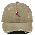 Detailed view of colorful parrot embroidery on khaki distressed washed cotton baseball cap - Khaki