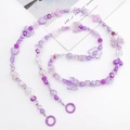 Detail of purple beaded crossbody chain with heart and flower shapes on white surface - Purple Mixed Color Beads