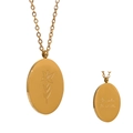 Vintage golden December Poinsettia flower necklace with engraved oval pendant on white backdrop - December Poinsettia