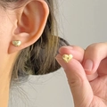 Polished gold heart studs shown on ear and held in hand for scale reference - Mini Gold Heart