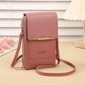 Detail of crossbody phone bag in dusty pink with textured leather and gold metal trim - Deep Pink