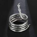 Detailed close-up of silver snake-shaped cuff with scale texture and black eyes - Engraved Silver