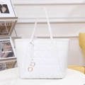 White faux leather tote bag with diamond quilting and metallic ring pendant charm - White