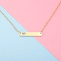 Close-up of golden rectangular bar necklace with a hollow heart on a pastel background - 18 inch / Gold