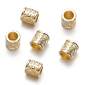 Detailed macro view of gold hollow-out floral pattern cylinder beads for DIY jewelry - Gold Style 13 (Hollow Tube)