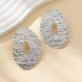 Irregular silver textured oval hoop earrings with a hammered finish and hollow design - Large Oval Cutout Hammered / Silver