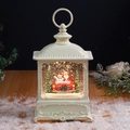 Close-up of ivory Christmas lantern with red vintage car and Santa inside glowing water globe - White Snowman & Car (With Music)