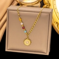 Close-up of golden sun pendant necklace with colorful beads on premium silk background - Solar Ray Colorful Bead (AH310) / Gold