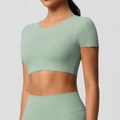 Close-up of mint green seamless yoga crop top fabric with high elasticity and snug fit - S / Basil Green