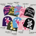 Detail view of colorful knit beanies featuring gothic lettering and star jacquard patterns - 201 Stainless Steel
