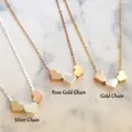 Detailansicht der dreifachen Herzanhänger-Halsketten in Silber, Roségold und Gold auf Marmor - Silber