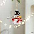 Christmas snowman resin ornament with black hat and red scarf hanging on a festive tree - Snowman With Heart