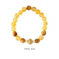Detail of citrine beaded bracelet featuring a hollow golden floral charm with rhinestones - Citrine Hollow Rhinestone Style (WB335)