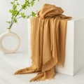 Linen cotton scarf in ginger yellow with tassel edges on a white cube display - Apricot Yellow