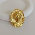 Macro shot of vintage golden metal lady head brooch with matte finish and relief details - 1 Piece / Gold