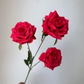 Detailed view of three artificial red diamond roses with green leaves and stems - Red
