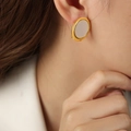 Vintage style gold oval stud earrings with cream faux shell inlay worn by model - Gold