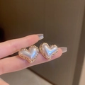 Elegant heart-shaped stud earrings with pearl white center and golden hammered texture - Heart Design Style / White