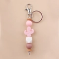 Close-up of pink cactus silicone beads and wooden hexagonal beads on a creative keychain - Pink
