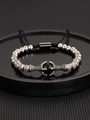 Gothic crown dragon claw bracelet with silver beads and black stone on a tray - Steel Color Dragon Claw Bracelet