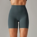 Detail of high-waist seamless compression yoga shorts in deep teal showing smooth fabric texture - Wood Green