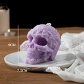 Purple Halloween skull candle with floral relief carving measuring 9cm in height - Purple (Lavender)