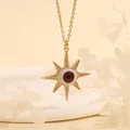 Detailed macro view of 18K gold-plated Evil Eye sunburst pendant with red iris and crystals - Reddish Brown Star-B1