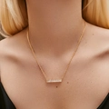 Detail of a gold LOVE necklace with rectangular zircons worn on a female neck - KN0449-Rectangular Bar Rhinestone