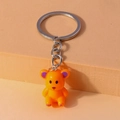 Detalle de un lindo llavero de oso de resina naranja con un anillo de metal plateado - Naranja