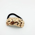 Detailed macro view of the irregular gold metal texture on a black elastic hair tie - Pleated Metallic Texture (3 Hair Ties)