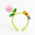 Detail of plush tulip headband with cute colorful caterpillar design and green soft fabric - Pink Tulip