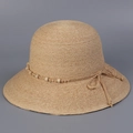 Detail of wide brim raffia sun hat showing handwoven texture with wooden beads and bow tie - M (56-58cm) / Natural