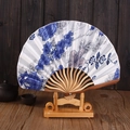 Japanese style brown rib folding fan with blue floral patterns on a wooden stand - No.6 Blue and White Porcelain Pattern