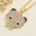Close-up of golden panda pendant with pavé set white and black zircon stones - Black Ear Bear Panda