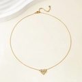 Detail of elegant gold heart pendant with sparkling zircons on a delicate chain necklace - 14k / Gold