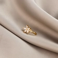 Macro detail of gold flower non-pierced nose clip with sparkling zircon inlay - Flower