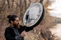Shaman drum with raven and dreamcatcher artwork including a black drumstick - Raven Totem Drum / 25cm