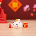 Cute white Lucky Cat Capybara ornament with gold coin and red fortune bag on wooden surface - Treasure Luck Cat (1081-18)